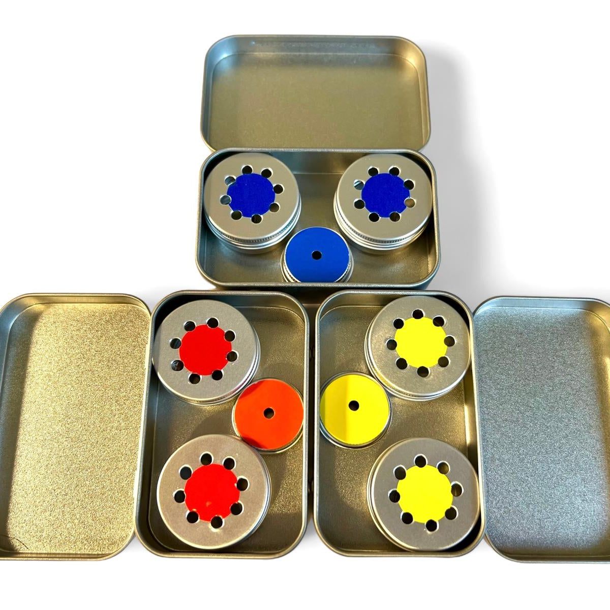 three tins in blue, red and yellow