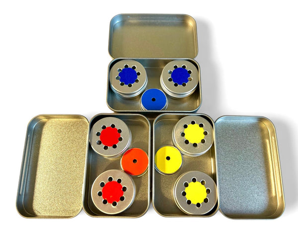 three tins in blue, red and yellow