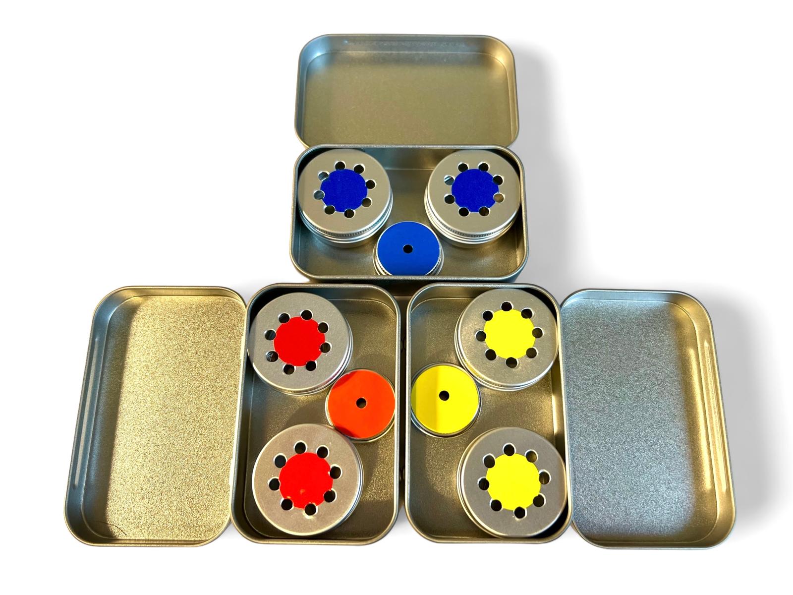 three tins in blue, red and yellow