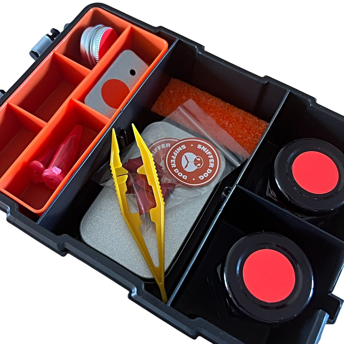 Dog scent training kit containing red-lidded magnetic tins, tweezers, glass vials, KONG chunks, and foam insert in a waterproof organiser.